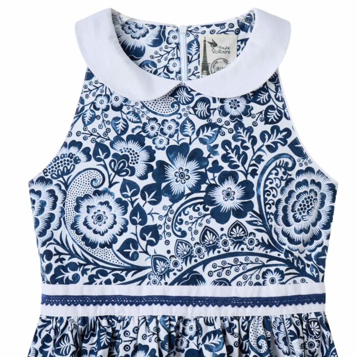Une Magnifique Robe Patineuse Été pour Fille et Fillette en Coton Fleuri Bleu Marine et Blanc, Col Claudine Blanc, Ceinture avec Zigzag Bleu Marine. Robe Qui Tourne et Noeud dans le Dos Idéale pour les Cérémonie, Tenue de mariage Enfant, Robe Chic pour la Rentrée Scolaire de la Marque de Mode Chic pour Enfant La Faute à Voltaire